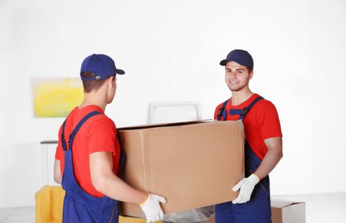 Removal company team loading boxes into a moving van