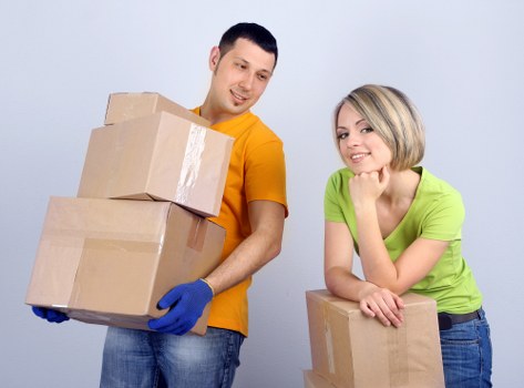 Professional movers packing and protecting furniture